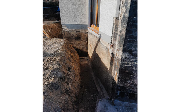 The moisture on the outer wall had to be removed as part of refurbishing the basement.