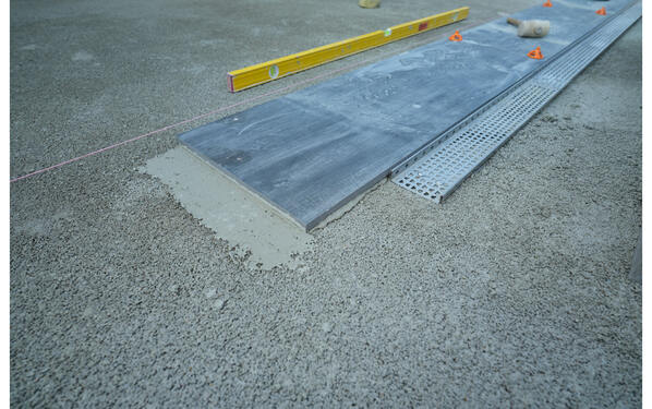 Leveling and laying of the terrace tiles along with the drainage channel